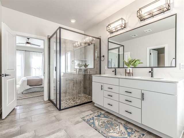 bathroom featuring vanity, ceiling fan, and a shower with shower door