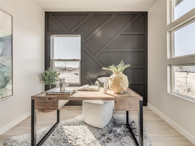 office area with light hardwood / wood-style floors