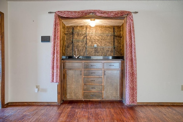 bar featuring dark hardwood / wood-style flooring