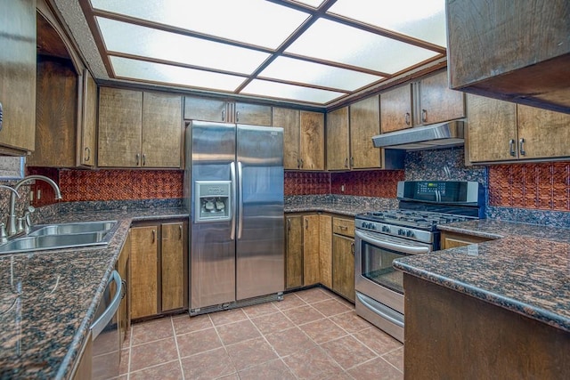 kitchen featuring sink, light tile patterned floors, and stainless steel appliances