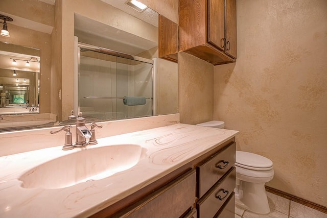 bathroom featuring tile patterned flooring, toilet, a shower with door, and vanity