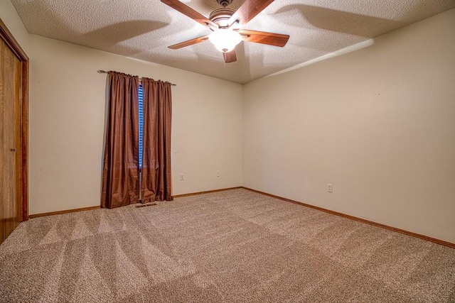 unfurnished room featuring carpet floors, a textured ceiling, and ceiling fan