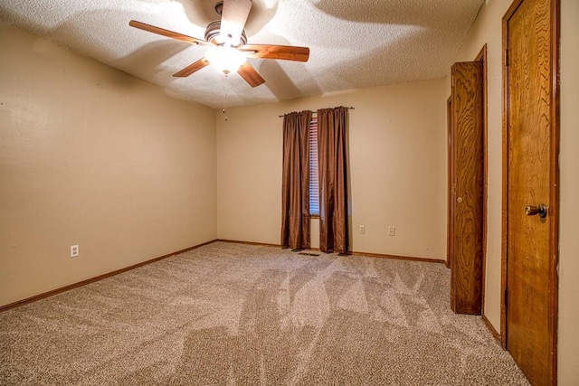 unfurnished room with light carpet, ceiling fan, and a textured ceiling