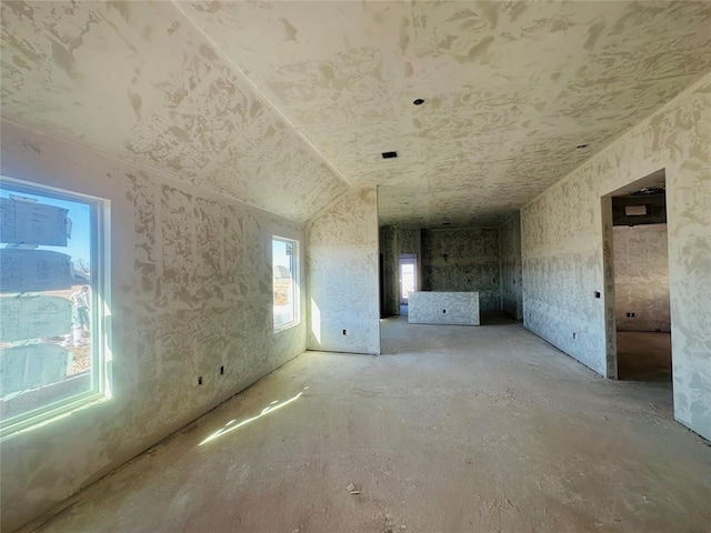 interior space featuring lofted ceiling and a healthy amount of sunlight