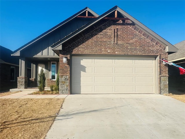 view of front of property featuring brick siding, board and batten siding, an attached garage, and concrete driveway