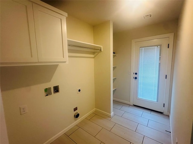 laundry area featuring visible vents, baseboards, washer hookup, cabinet space, and hookup for an electric dryer