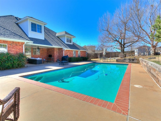 view of swimming pool featuring a patio, fence, and a fenced in pool