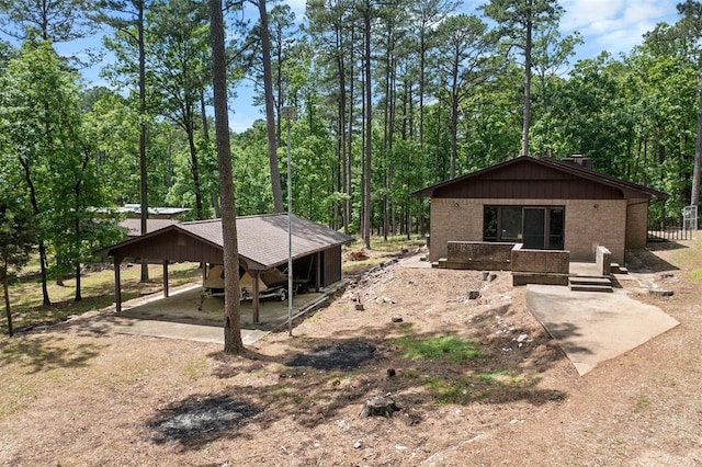 back of house with a carport