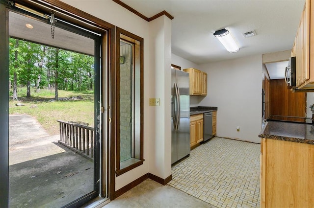 kitchen with crown molding and appliances with stainless steel finishes