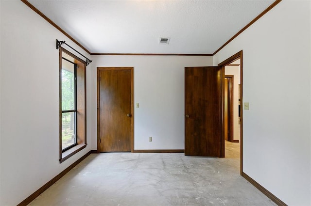 spare room featuring crown molding and a healthy amount of sunlight