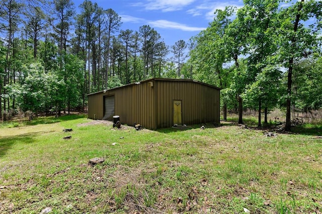 view of outbuilding featuring a garage and a lawn