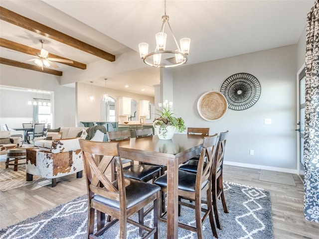 dining space featuring ceiling fan with notable chandelier, hardwood / wood-style floors, and beam ceiling