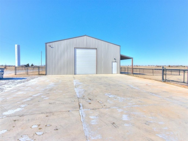 view of outdoor structure with a garage and a rural view