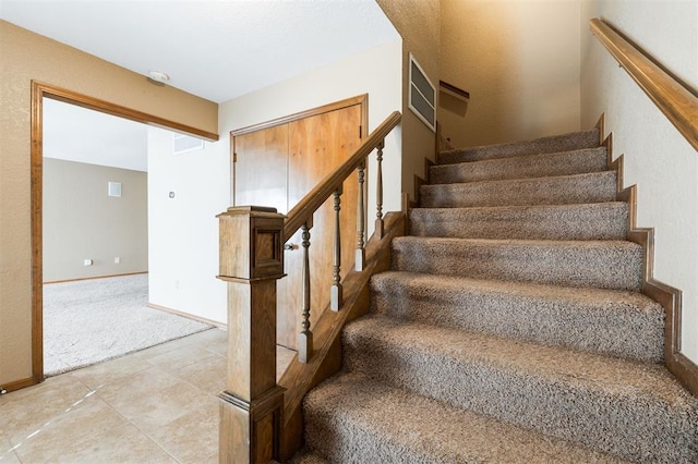 stairs featuring carpet