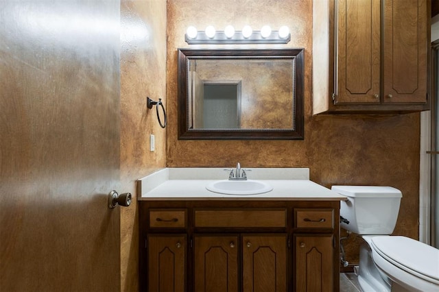 bathroom with toilet and vanity