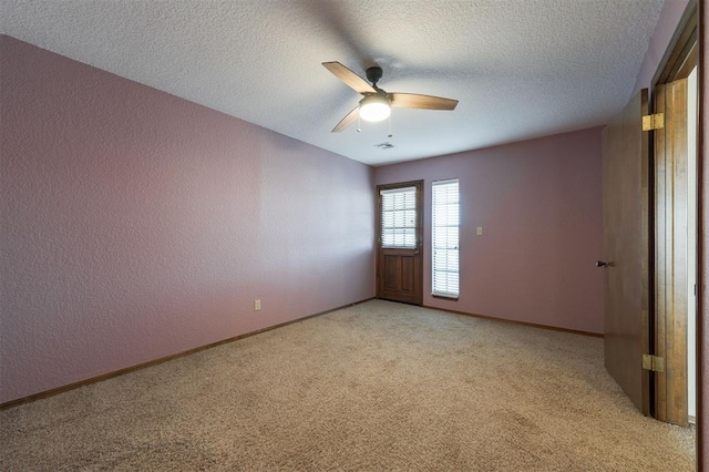 spare room with light carpet, a textured ceiling, and ceiling fan