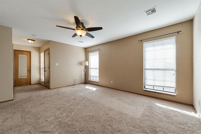 empty room featuring light carpet and ceiling fan