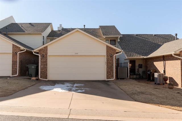 front facade featuring a garage and central AC unit