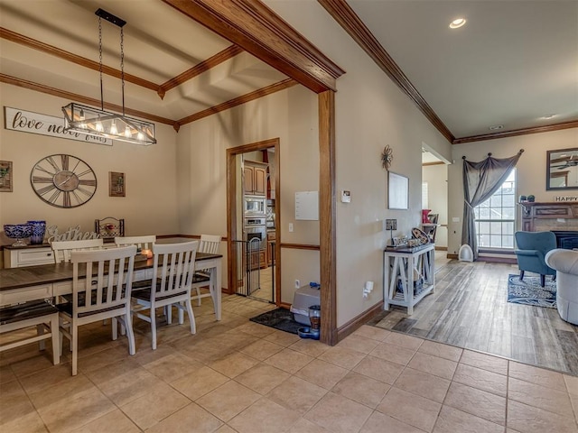 tiled dining space featuring ornamental molding