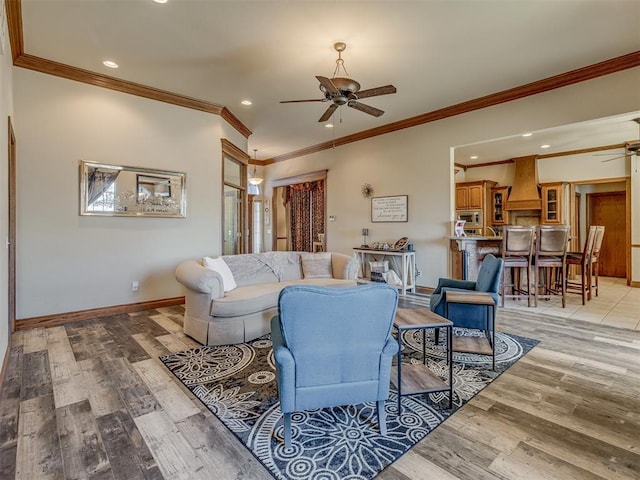 living room with crown molding, ceiling fan, and light hardwood / wood-style flooring