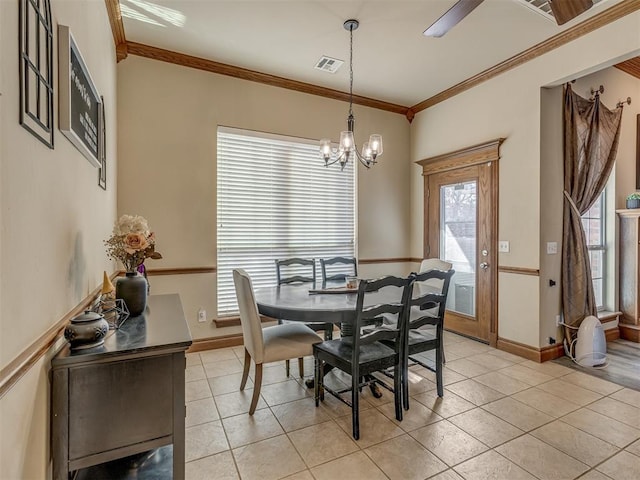 dining room featuring light tile patterned floors, crown molding, and a notable chandelier