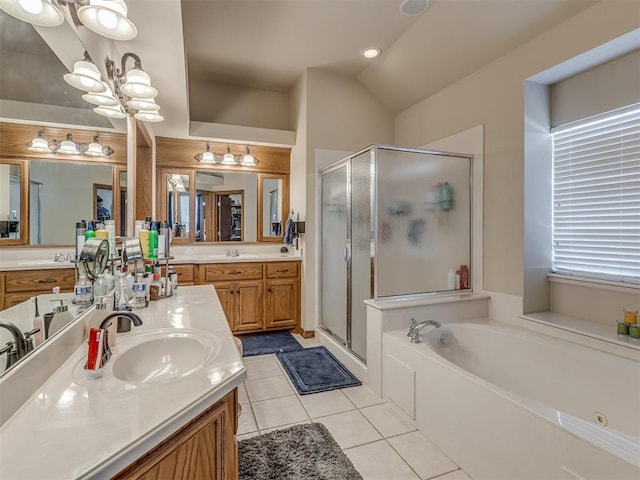 bathroom featuring plus walk in shower, tile patterned floors, an inviting chandelier, and vanity