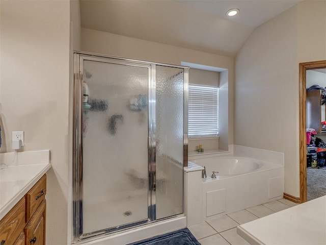 bathroom featuring vanity, separate shower and tub, tile patterned floors, and lofted ceiling