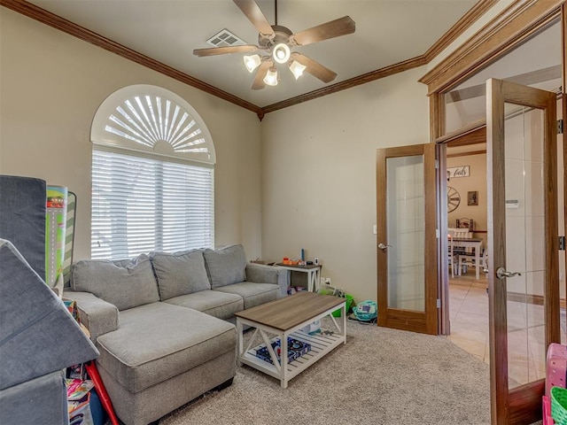 living room featuring french doors, ceiling fan, ornamental molding, and carpet floors