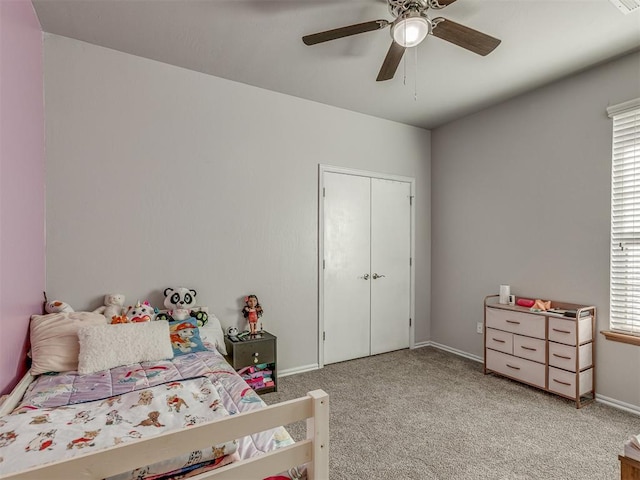 carpeted bedroom featuring multiple windows, ceiling fan, and a closet