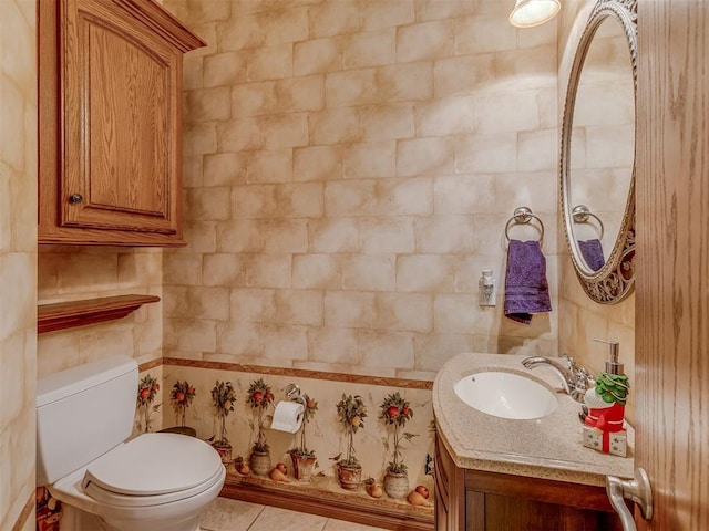 bathroom featuring vanity, tile patterned floors, and toilet