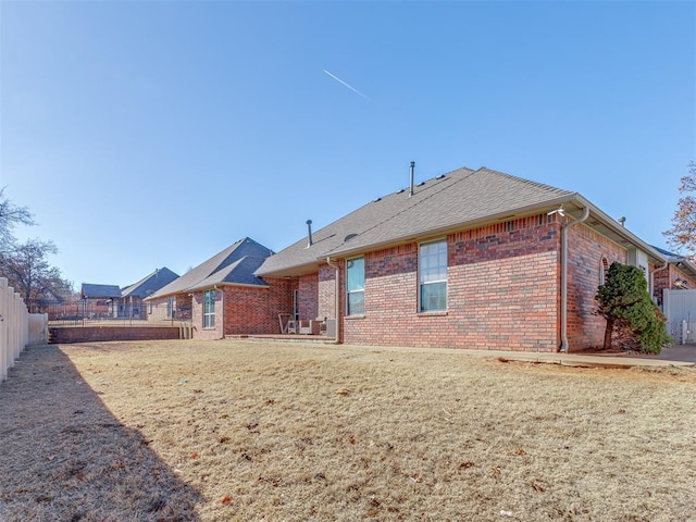 rear view of property with a lawn