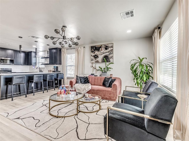 living room with sink and light hardwood / wood-style floors