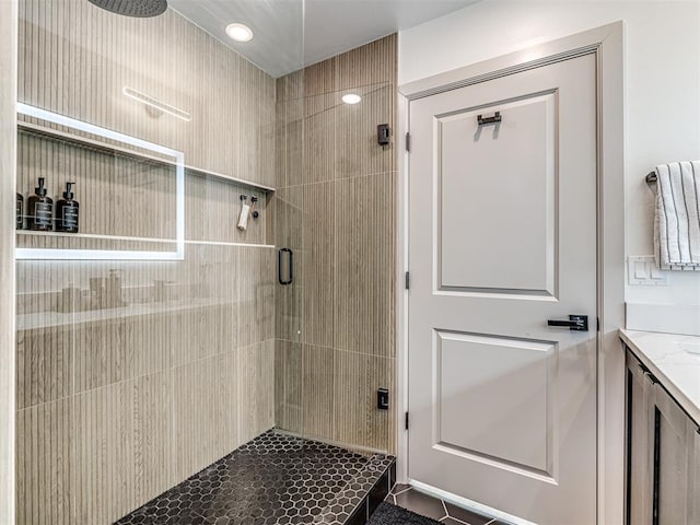 bathroom featuring vanity and a shower with shower door