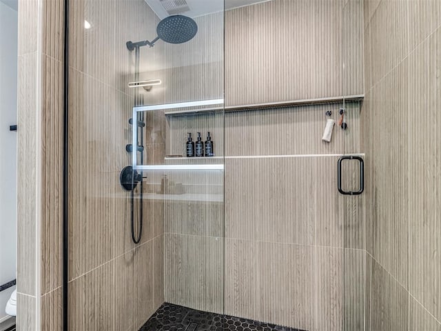 bathroom featuring a shower with shower door