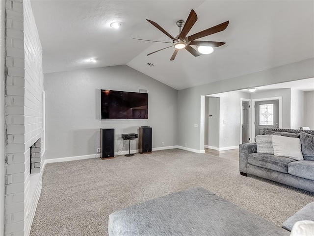 living room with a fireplace, ceiling fan, vaulted ceiling, and carpet