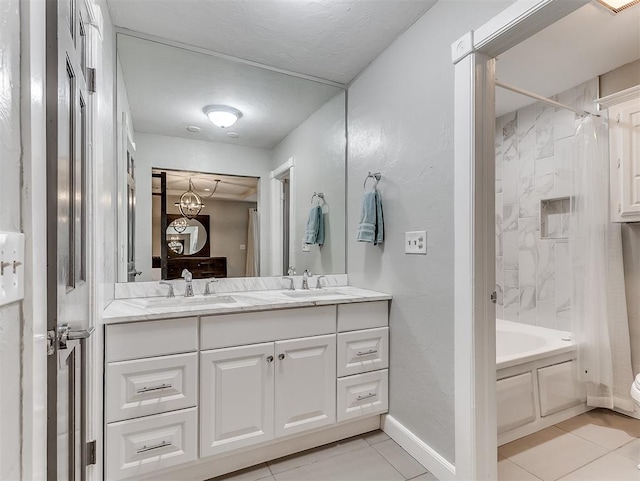 full bathroom with tile patterned floors, tiled shower / bath combo, vanity, and toilet