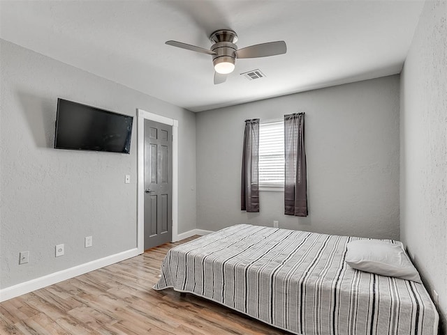 bedroom with ceiling fan and light hardwood / wood-style floors