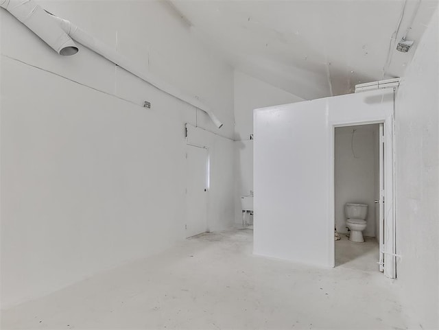 bathroom featuring concrete floors and toilet