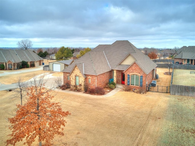 view of front facade with a garage, an outdoor structure, and a front lawn