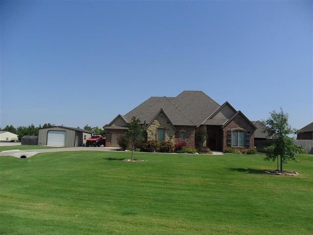 view of front of house featuring a garage and a front lawn