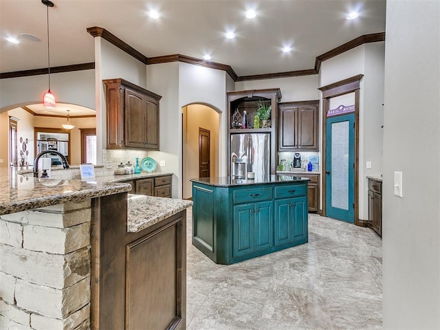 kitchen featuring decorative light fixtures, stainless steel fridge with ice dispenser, kitchen peninsula, dark stone counters, and backsplash