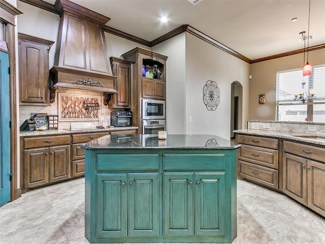 kitchen featuring premium range hood, a kitchen island, built in microwave, oven, and dark stone counters