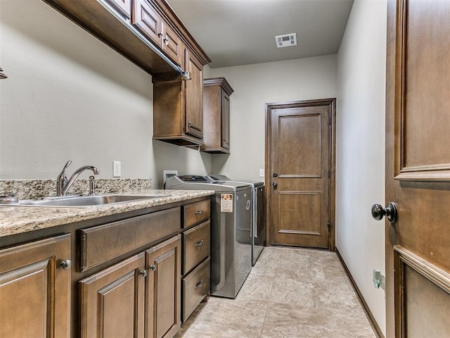 laundry area with sink, cabinets, and washing machine and clothes dryer