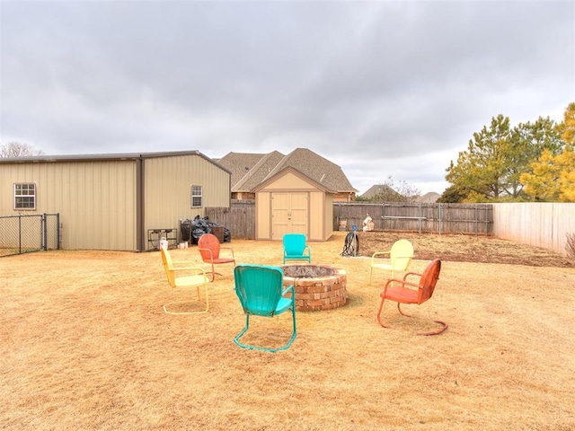 view of yard with a storage unit and an outdoor fire pit