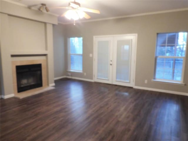 unfurnished living room with ceiling fan, french doors, dark hardwood / wood-style flooring, and ornamental molding