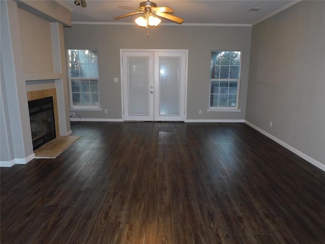 unfurnished living room with ceiling fan, a fireplace, crown molding, and dark hardwood / wood-style floors