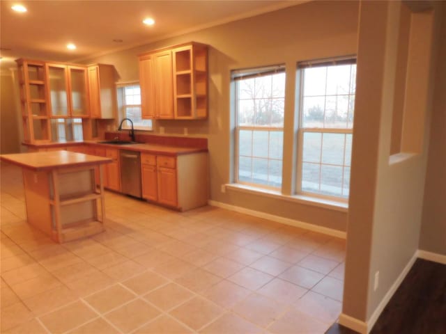 kitchen featuring light tile patterned floors, light brown cabinetry, dishwasher, and sink