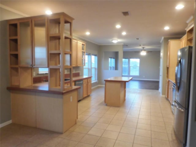 kitchen with kitchen peninsula, light tile patterned flooring, stainless steel appliances, and ornamental molding