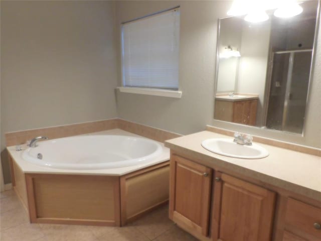 bathroom featuring plus walk in shower, tile patterned floors, and vanity