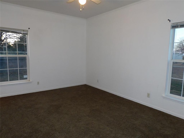 empty room featuring ceiling fan and dark colored carpet